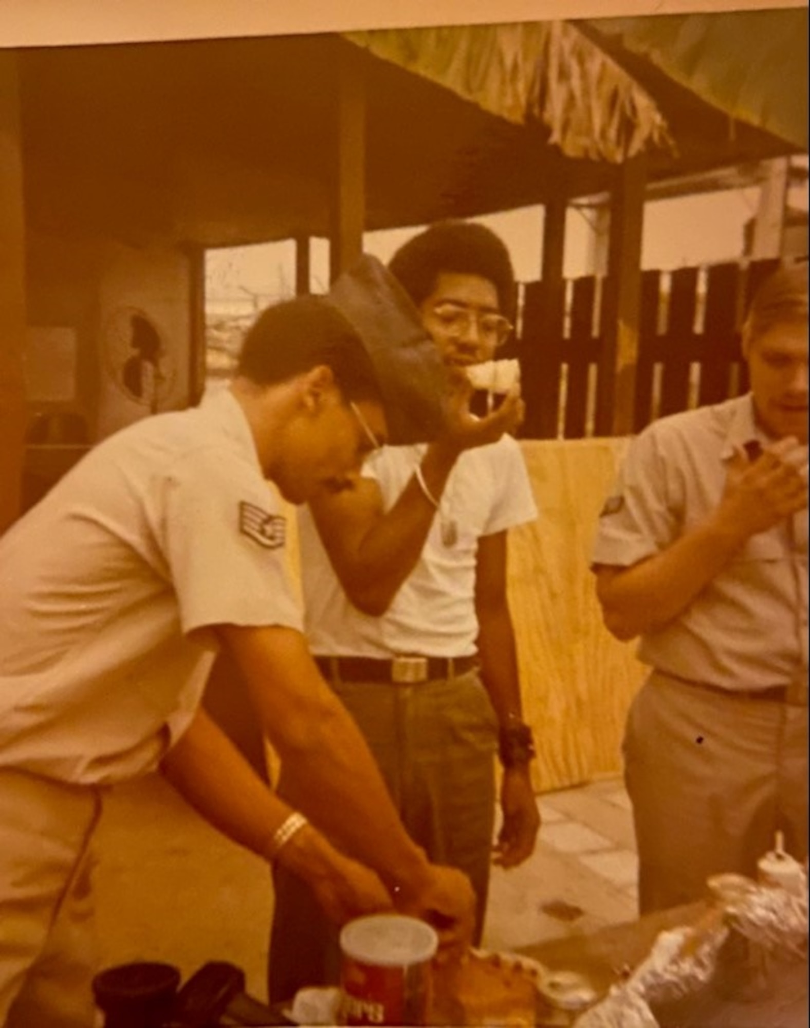 Office of Special Investigations personnel feasting on Charles Ashe's birthday cake at Tan Son Nhut Air Base, Vietnam. (Courtesy Charles Ashe photo).