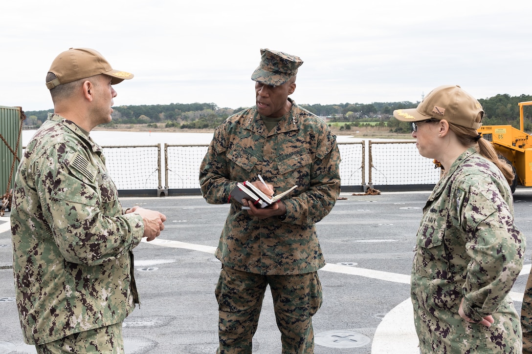 U.S. Marine Corps Lt. Gen. Michael E. Langley (center), the commander of Fleet Marine Force, Atlantic, Marine Forces Command, Marine Forces Northern Command, speaks with U.S. Navy Rear. Adm. John V. Menoni (left), the commander of Expeditionary Strike Group 2 (ESG-2), and Cmdr. Elizabeth A Nelson, commanding officer of the Whidbey Island-class dock landing ship USS Gunston Hall (LSD 44), while touring the ship on March 25, 2022, prior to a regularly scheduled deployment. The USS Gunston Hall is one of the three Kearsarge Amphibious Ready Group dock landing ships scheduled to join 22nd Marine Expeditionary Unit who deployed earlier this month. (U.S. Marine Corps photo by Mr. Casey Price)
