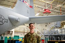 Photo of Airmen from the 165th Airlift Wing posing for a photo in the aircraft hangar