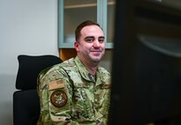 Photo of Airmen from the 165th Airlift Wing working at his desk