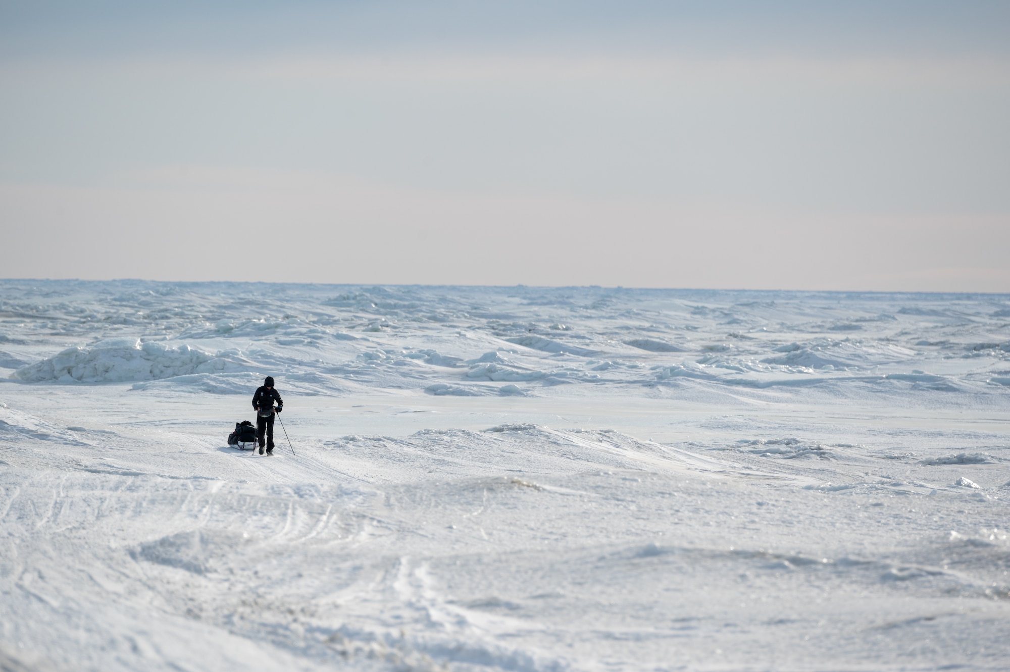 Maj. Joshua Brown hikes across icy terrain.