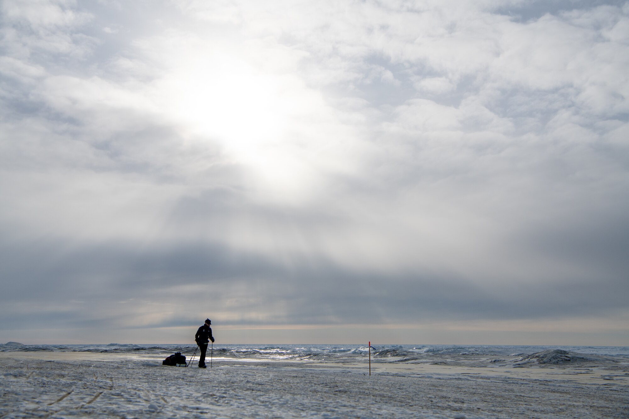 Maj. Joshua Brown hikes across icy terrain.