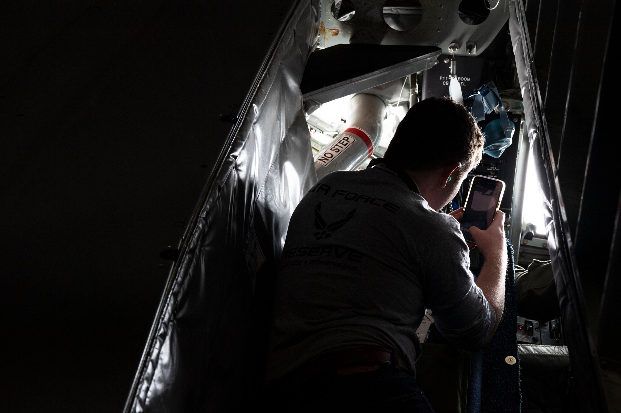 A Development and Training Flight trainee snaps a photo of a B-2 Spirit during in-air refueling on a KC-135R Stratotanker, March 5, 2022, Grissom Air Reserve Base, Indiana. The D&TF prepares the trainees for Basic Military Trainee and their future careers in the Air Force. (U.S. Air Force photo by Staff Sgt. Alexa Culbert)