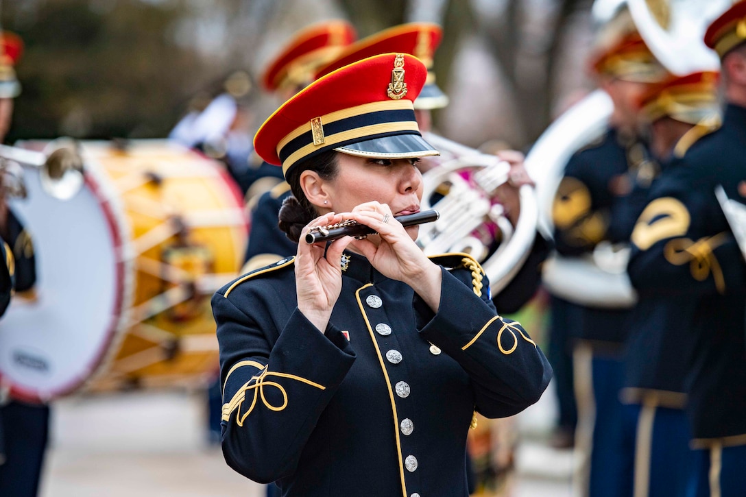 A soldier plays an instrument.