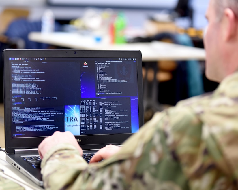 U.S. Air Force Capt. Shannon Bender, 272nd Cyber Operations Squadron, 110th Wing, Michigan Air National Guard, reviews computer information during a cyber-warfare training event, Camp Grayling Joint Maneuver Training Center, Michigan, March 8, 2022. The Cyber Strike exercise focused on replicating a live training environment utilizing key personnel from different organizations consisting of law enforcement, prosecutors, detectives, and the Michigan Air National Guard and used a closed network that ran a malware application. (U.S. Air National Guard photo by Master Sgt. David Eichaker)