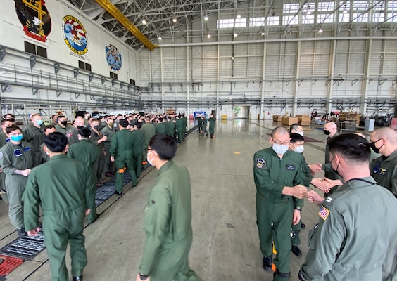 KADENA AIR BASE, Japan (March 28, 2022) – Members of Japan Maritime Self-Defense Force Air Reconnaissance Squadron EIGHT ONE (VQ-81) and Fleet Air Reconnaissance Squadron ONE (VQ-1) greet each other during Raijin 22-1, an annual unit exchange. Based out of Whidbey Island, Washington, the VQ-1 “World Watchers” are currently operating from Kadena Air Base in Okinawa, Japan. The squadron conducts naval operations as part of a rotational deployment to the U.S. 7th Fleet area of operations. (U.S. Navy photo by Mass Communication Specialist First Class Glenn Slaughter)