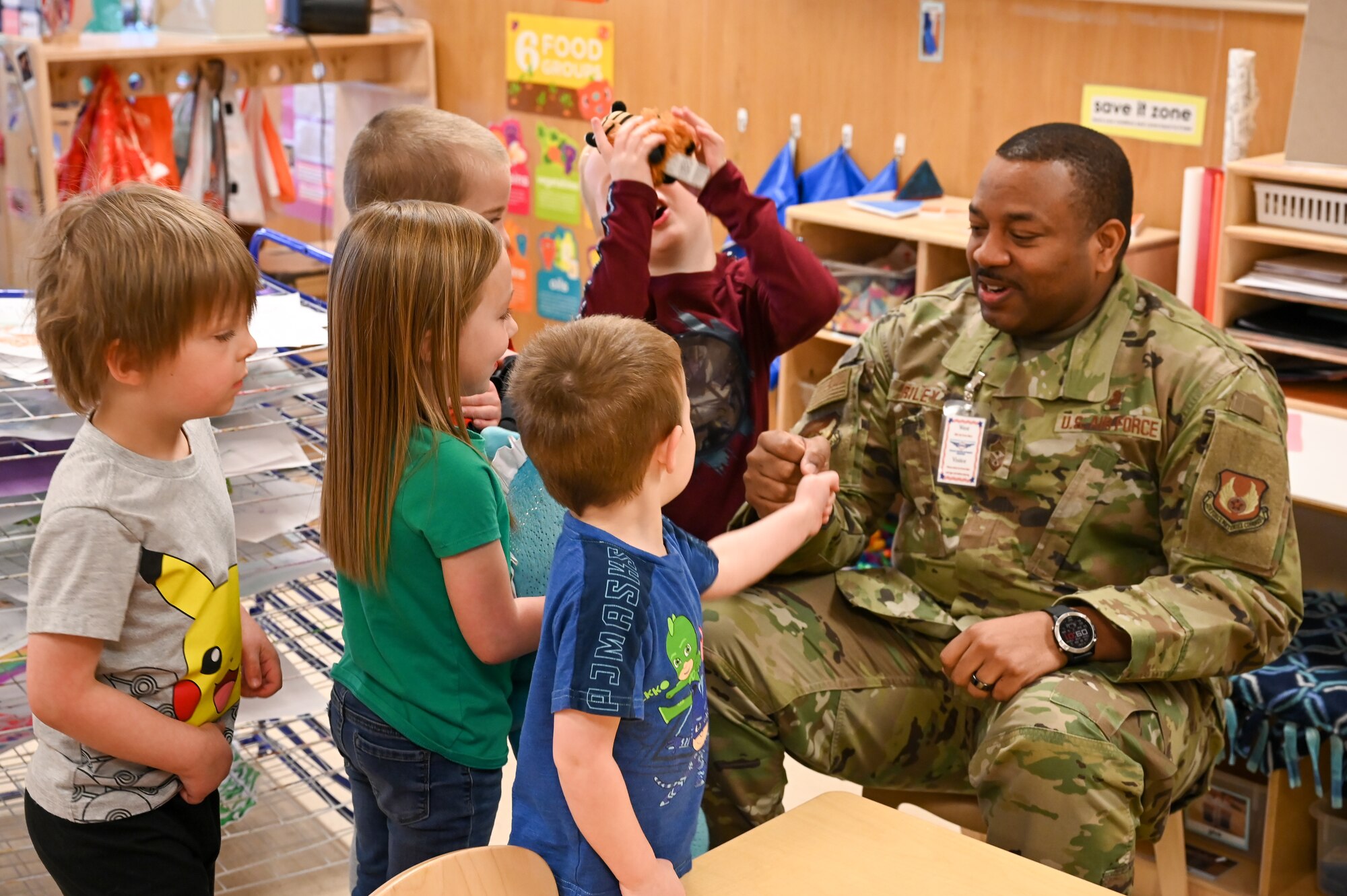 Chief Master Sgt. Raymond Riley, 75th Air Base Wing command chief, greets children at the Child Development Center during the proclamation signing ceremony for the Month of the Military Child, March 29, 2022, at Hill Air Force Base, Utah.