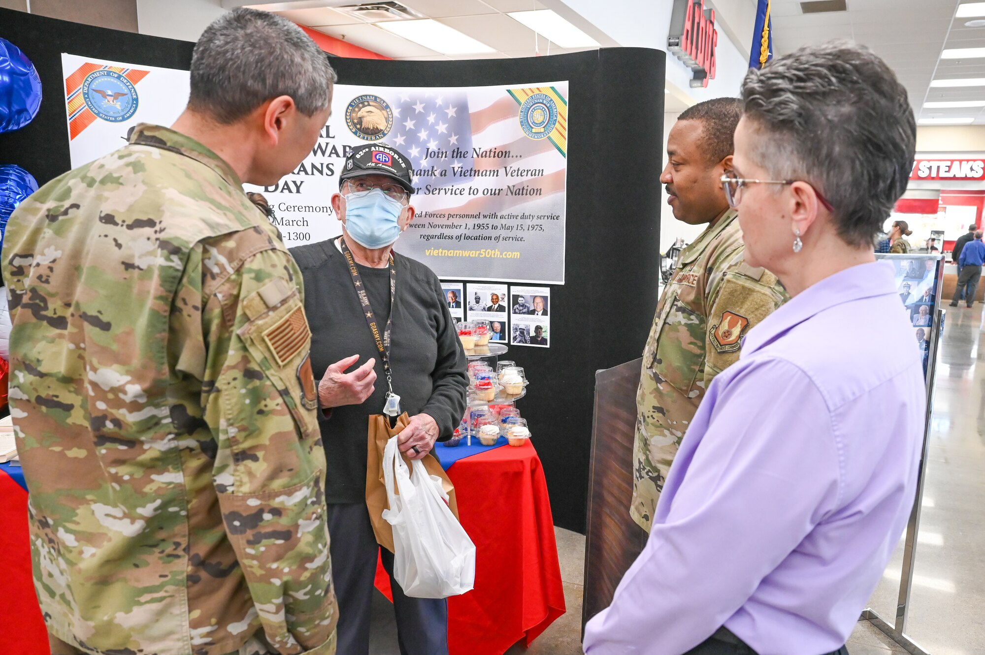 Col. Peter Feng, 75th Air Base Wing vice commander (left), Tammy Hairston, Army and Air Force Exchange Service general manager, and Chief Master Sgt. Raymond Riley, 75th Air Base Wing command chief, talk to retired U.S. Army Col. Corless Mitchell during the National Vietnam Veterans Day pinning ceremony March 29, 2022, at Hill Air Force Base, Utah. The Vietnam War Veterans Recognition Act of 2017 established March 29 as the day to honor Vietnam Veterans and their families. (U.S. Air Force photo by Cynthia Griggs)