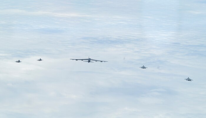 A bilateral formation of two Japanese Air Self-Defense Force F-15s, U.S. Air Force F-35As from Eielson Air Force Base, Alaska, and a B-52H Stratofortress, from Barksdale Air Force Base, Louisiana, fly over the Indo-Pacific region during a mission, Feb. 24, 2022.  The U.S. routinely and visibly demonstrates commitment to our allies and partners through the global employment of our military forces. (U.S. Air Force photo by Master Sgt. Burt Traynor)