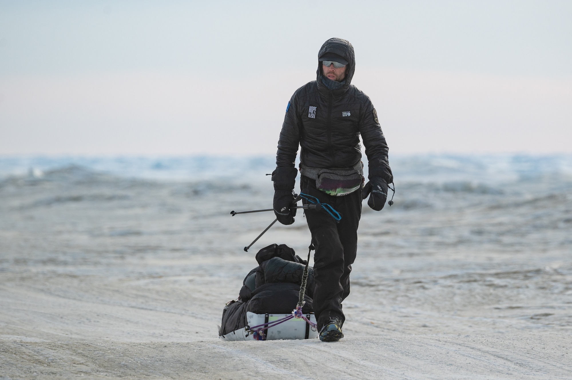 Maj. Joshua Brown hikes across icy terrain.