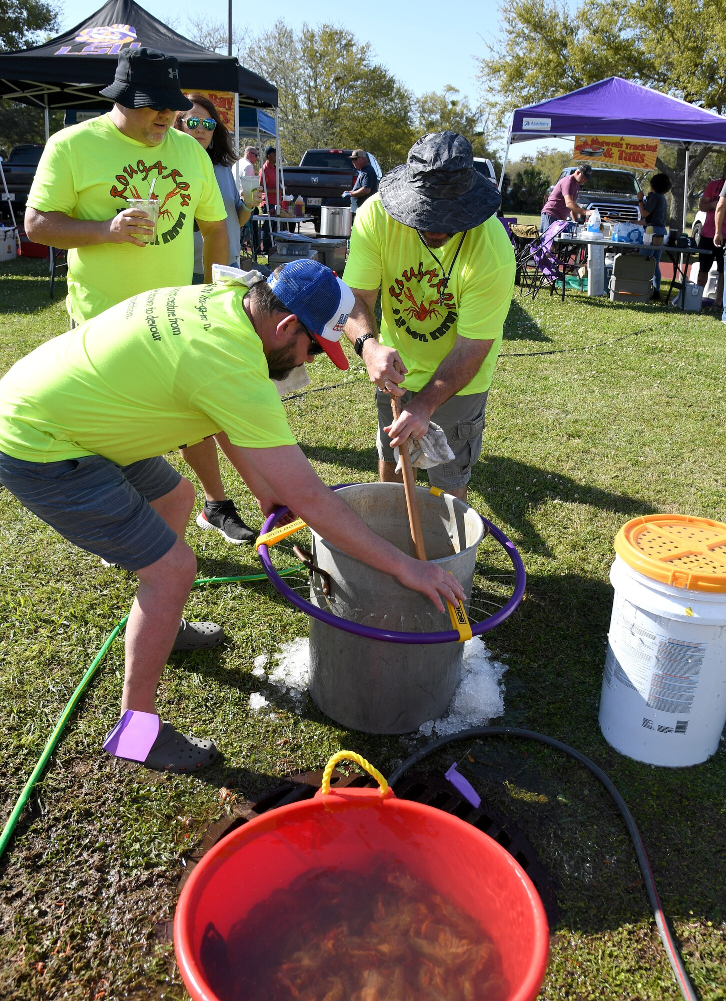 Members of team Rougarou stir their pot of boiled crawfish during the 10th Annual Crawfish Cook-Off at the Bay Breeze Event Center on Keesler Air Force Base, Mississippi, March 25, 2022. More than 20 teams competed in the event and more than 1,500 pounds of crawfish were distributed. (U.S. Air Force photo by Kemberly Groue)