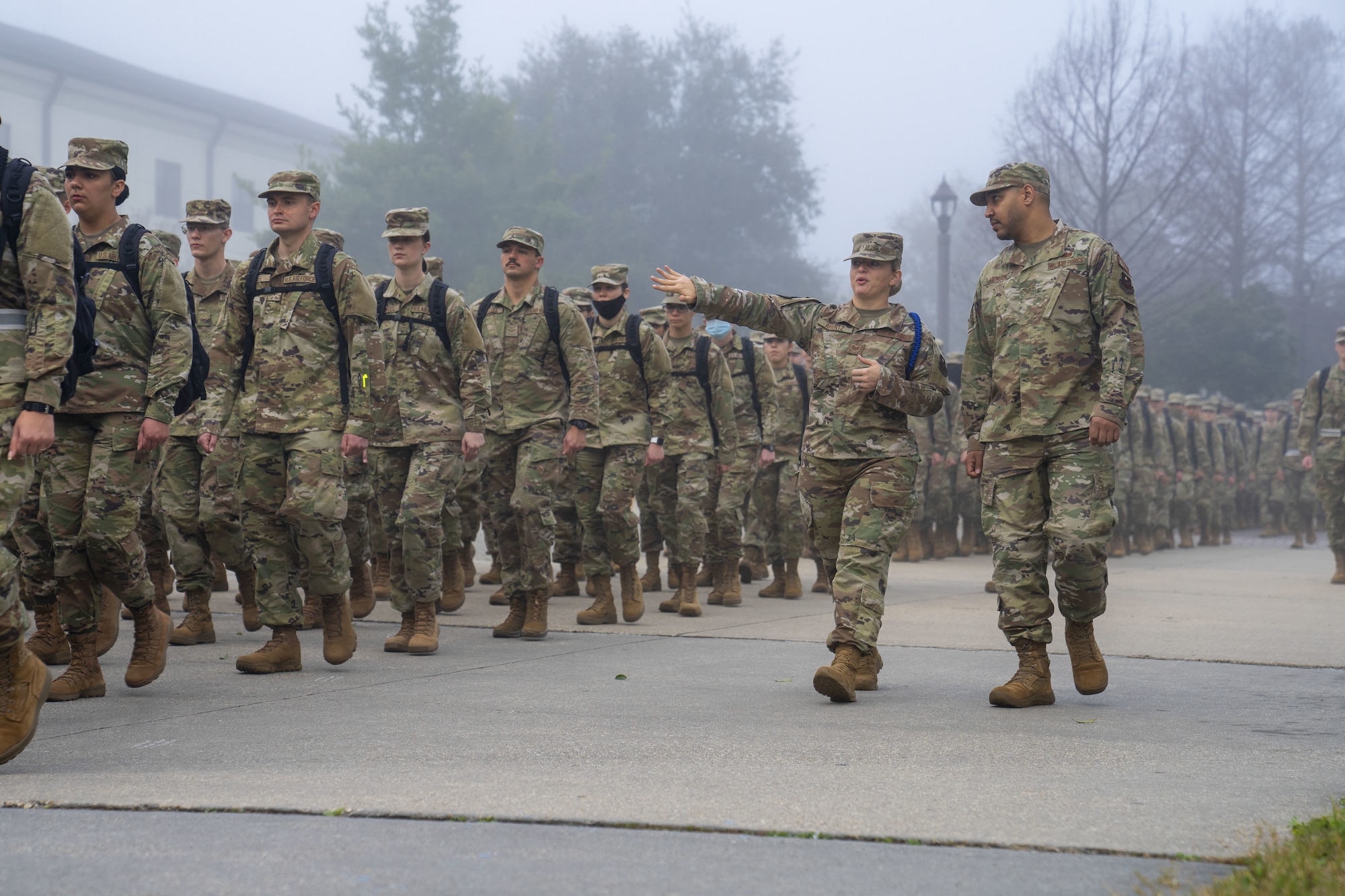 U.S. Air Force Tech Sgt. Dynasty Arentz, 334th Training Squadron Master Military Training Leader, teaches Staff Sgt. Marcus Johnson, 81st Training Support Squadron Keesler Technical Training Environment NCO in charge, about marching Airmen at Keesler Air Force Base, Mississippi, Feb. 23, 2022. Arentz was shadowed by Johnson to introduce him to the daily duties of an MTL before he joins the career field. (U.S. Air Force photo by Senior Airman Kimberly L. Mueller)