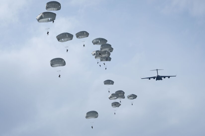 Photo of paratroopers jumping out of a C-17
