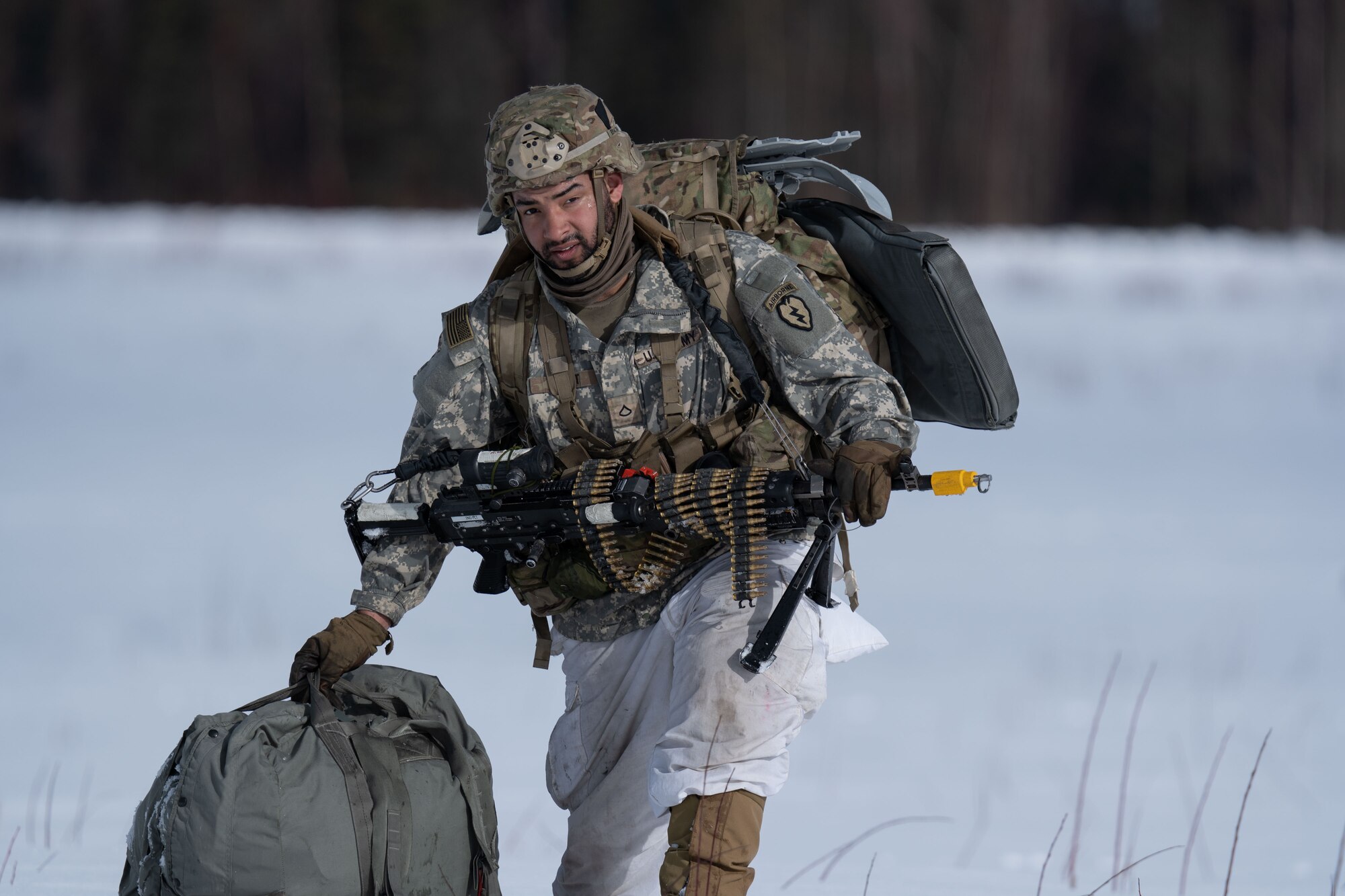 Photo of a Army paratrooper heading to the rally point after jumping C-17
