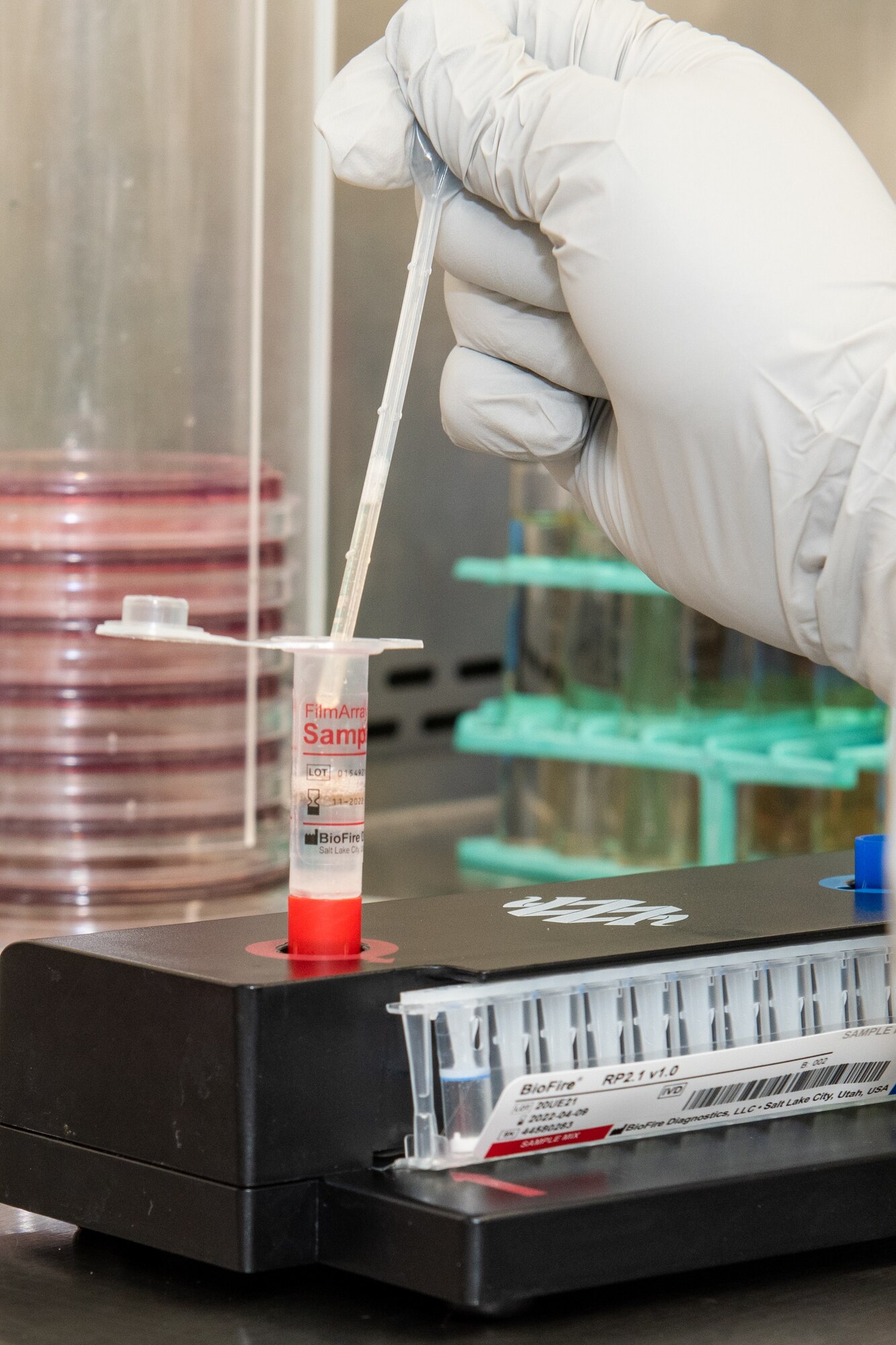 A photo of a lab technician preparing a COVID-19 sample for testing.