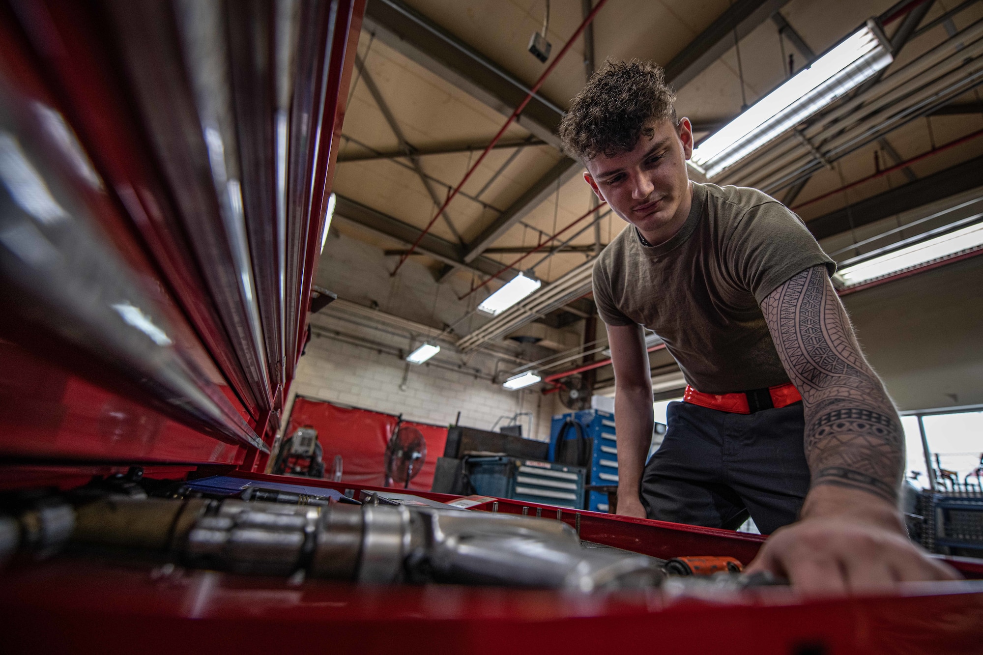 Airman reaches for a drill.