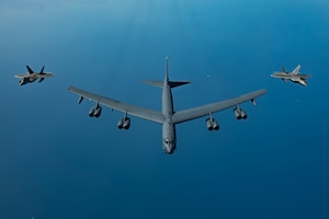 U.S. Air Force F-22 Raptors fly alongside a U.S. Air Force B-52H Stratofortress above the Arabian Gulf, March 29, 2022. The presence of the B-52H and F-22s showcased U.S. Central Command's ability to deliver combat airpower at a moment's notice, as well as its commitment to partners and regional security. (U.S. Air Force photo by Staff Sgt. Jerreht Harris)