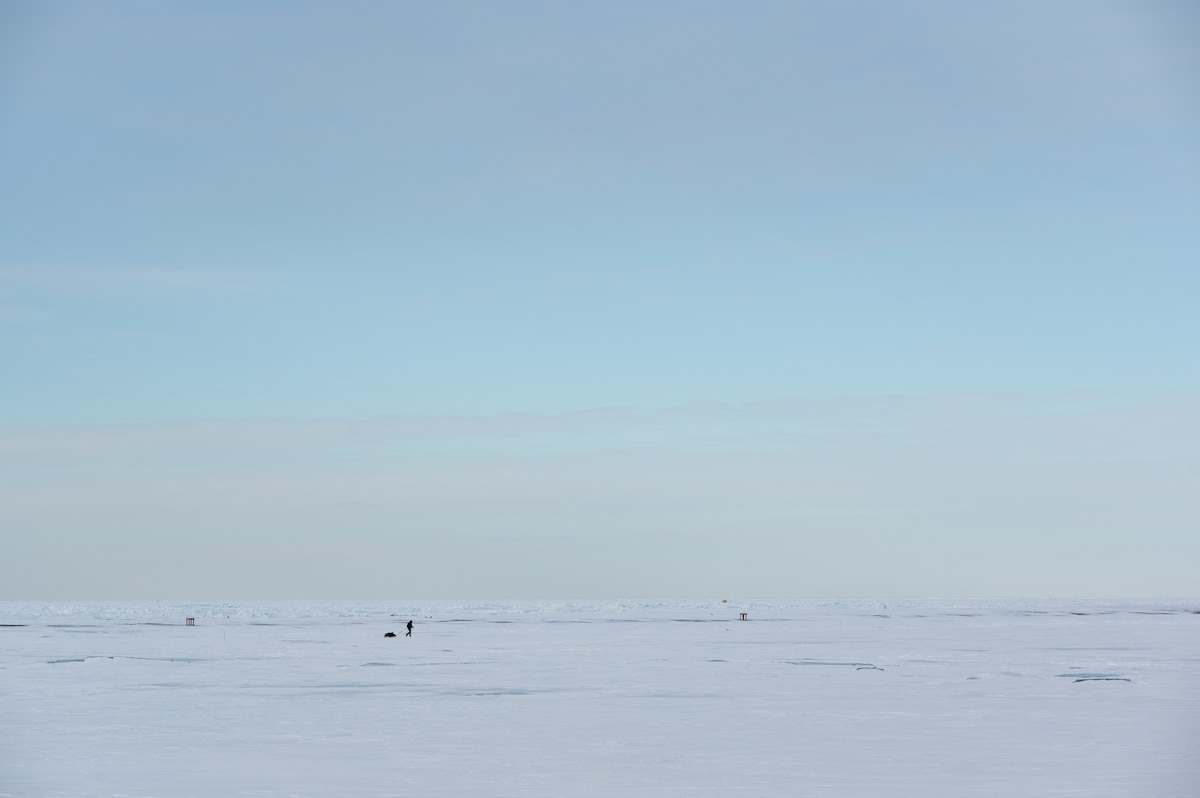 Maj. Joshua Brown hikes across icy terrain.