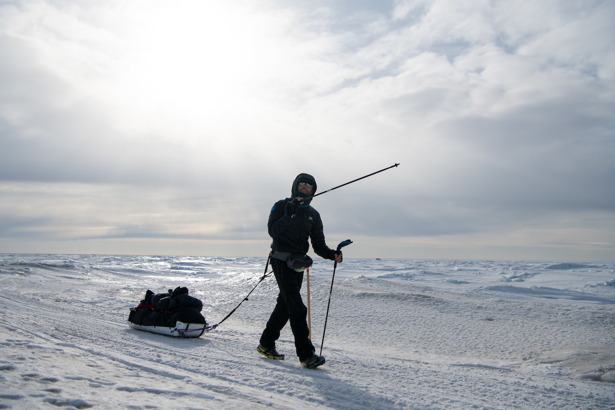 Maj. Joshua Brown hikes across icy terrain.