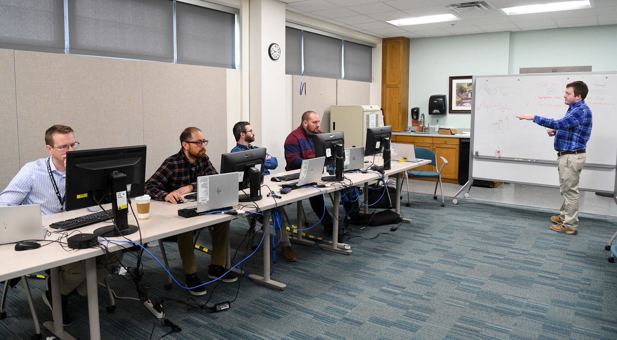 Dr. Justin Garrard, right, AEDC team member, leads a discussion with members of the Facility Maintenance Data Analysis team during the Air Force Test Center Data Hackathon, March 15, 2022.