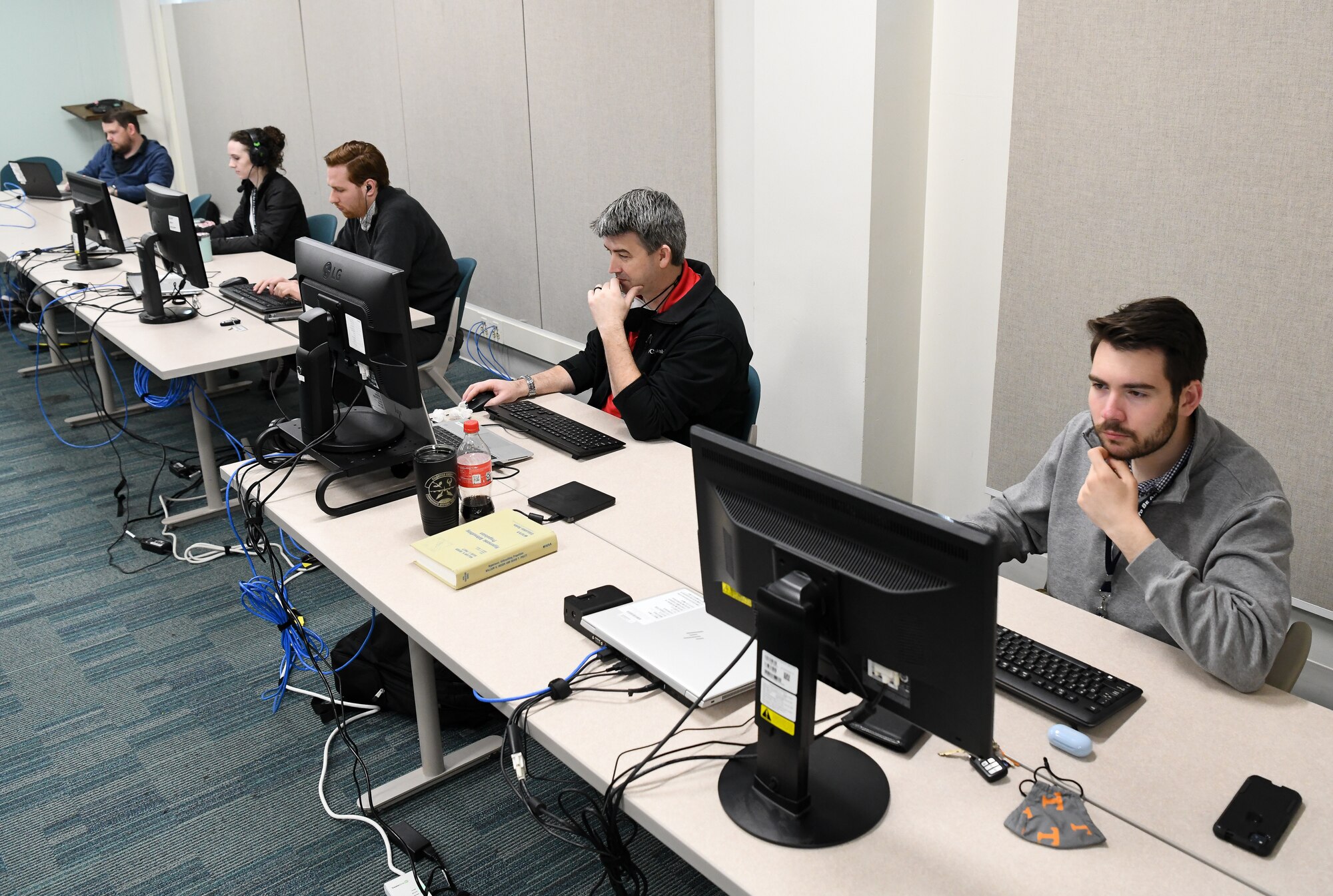 Members of the Arnold Engineering Development Complex Geographically Agnostic Analysis team for the Air Force Test Center Data Hackathon  work on their effort during the hackathon, March 15, 2022, at Arnold Air Force Base, Tenn.