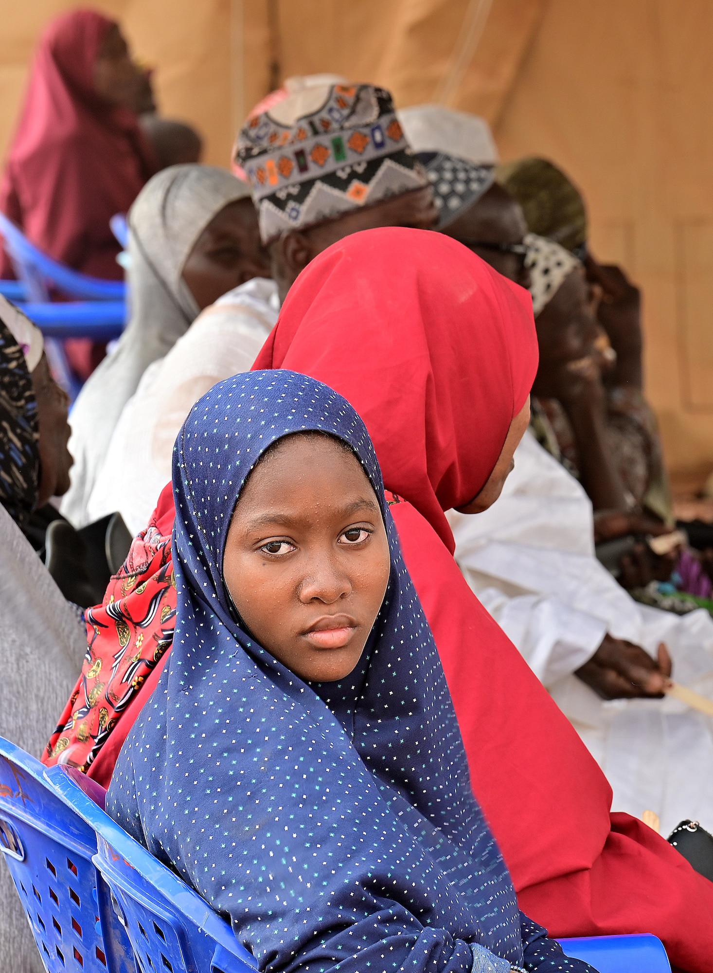A young Nigerien girl waits to be seen during a medical civic action program (MEDCAP) at Ouallam, Niger, March 16, 2022. The Niger-U.S. joint MEDCAP provided medical treatment to approximately 550 patients, ranging from small children to the elderly. (U.S. Air Force photo by Tech. Sgt. Stephanie Longoria)