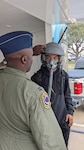 Capt. Wesley Cobb (left), a C-40 B/C pilot from the 1st Airlift Squadron at Joint Base Andrews, Maryland, helps a student try on a flight helmet at one of several schools he visited in Houston as a volunteer with Air Force Recruiting Service Detachment 1