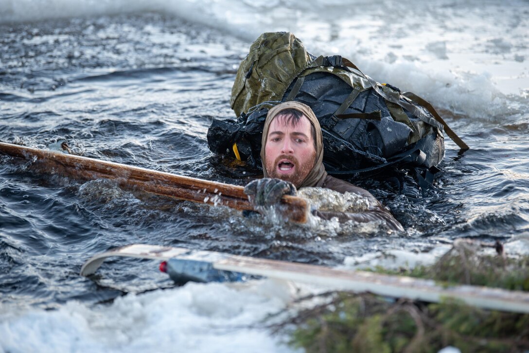 Master Sergeant Joshua Busch, a combat controller with the Kentucky Air National Guard’s 123rd Special Tactics Squadron, collects gear in the “ice bath” of a frozen lake in Grubbnäsudden, Sweden, Jan. 14, 2022. Fifteen members from the 123rd STS — including combat controllers; pararescuemen; special reconnaissance personnel; search, evasion, resistance and escape troops; and support Airmen — came here to build upon their relationship with European partners during an arctic warfare training course. (U.S. Air National Guard photo by Phil Speck)