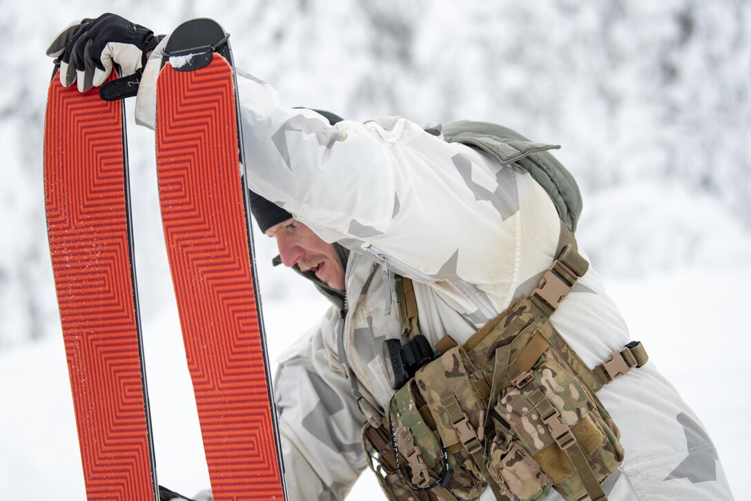 Master Sgt. Matthew Cothron, a search, evasion, resistance and escape instructor with the Kentucky Air National Guard’s 123rd Special Tactics Squadron, inspects his skis in Grubbnäsudden, Sweden, Jan. 11, 2022. Fifteen members from the 123rd STS — including combat controllers; pararescuemen; special reconnaissance personnel; search, evasion, resistance and escape troops; and support Airmen — came here to build upon their relationship with European partners during an arctic warfare training course. (U.S. Air National Guard photo by Phil Speck)