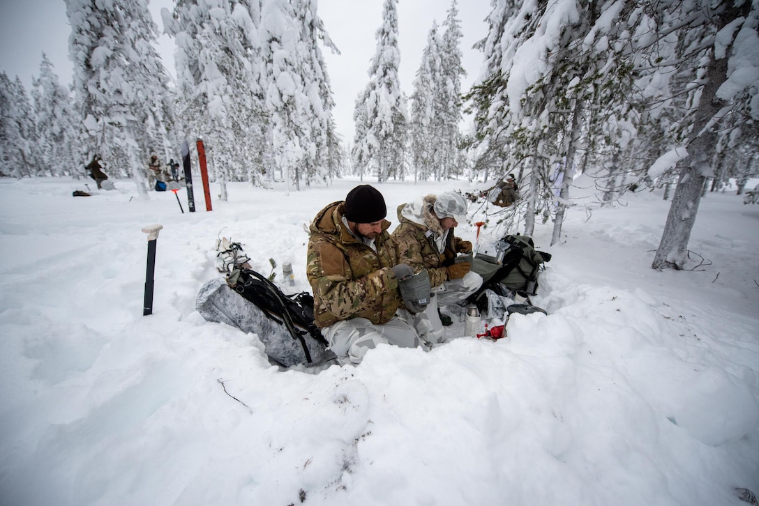 Airmen with the Kentucky Air National Guard’s 123rd Special Tactics Squadron, eat a meal in the field in Grubbnäsudden, Sweden, Jan. 11, 2022. Fifteen members from the 123rd STS — including combat controllers; pararescuemen; special reconnaissance personnel; search, evasion, resistance and escape troops; and support Airmen — came here to build upon their relationship with European partners during an arctic warfare training course. (U.S. Air National Guard photo by Phil Speck)