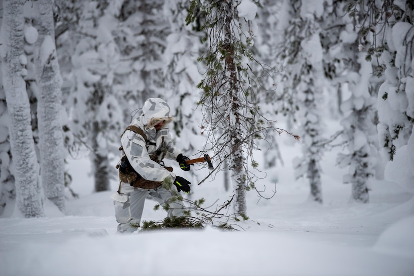 A combat controller with the Kentucky Air National Guard’s 123rd Special Tactics Squadron cuts kindling for a fire in Grubbnäsudden, Sweden, Jan. 11, 2022. Fifteen members from the 123rd STS — including combat controllers; pararescuemen; special reconnaissance personnel; search, evasion, resistance and escape troops; and support Airmen — came here to build upon their relationship with European partners during an arctic warfare training course. (U.S. Air National Guard photo by Phil Speck)