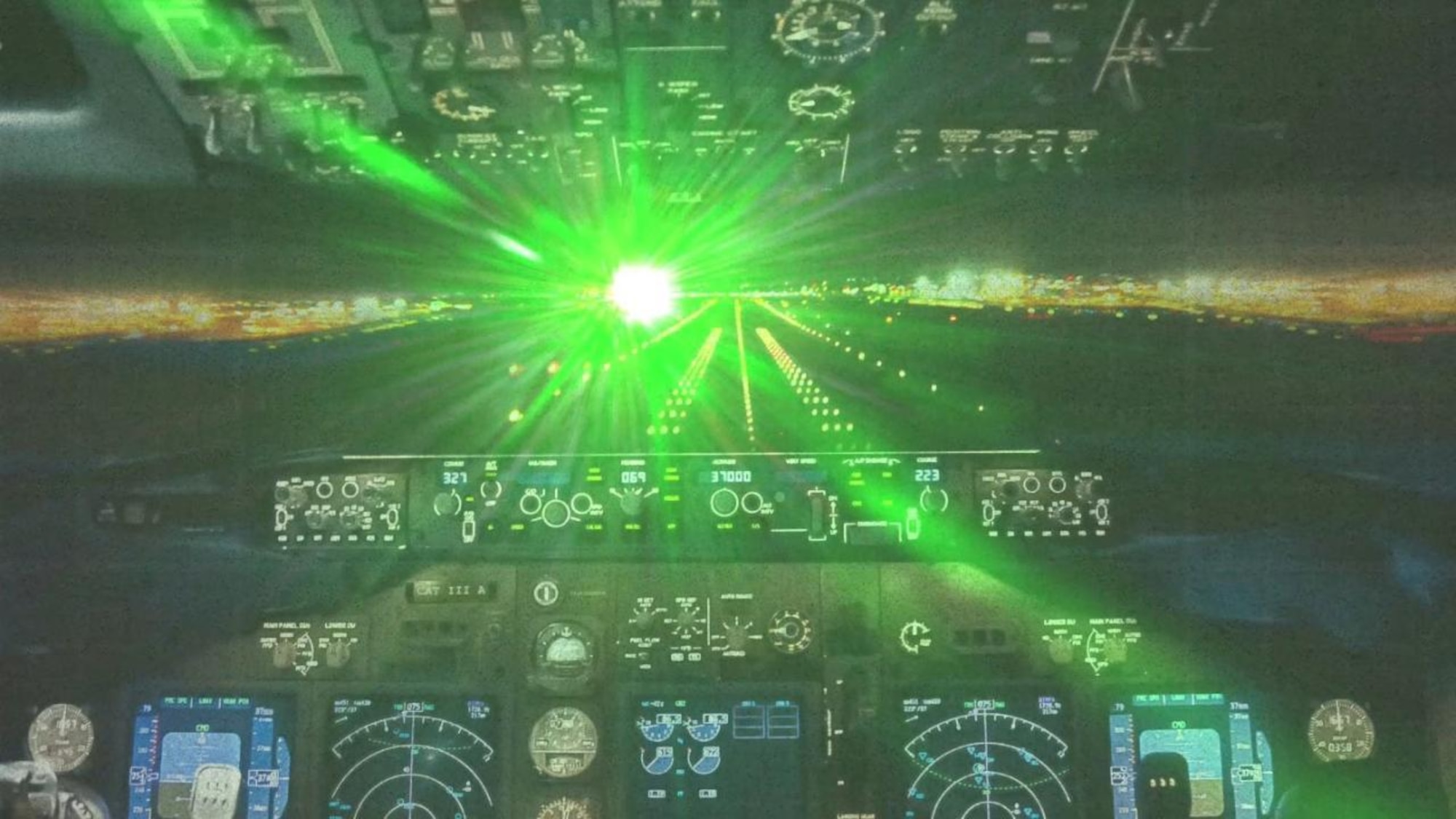 Laser light shines in an aircraft cockpit.