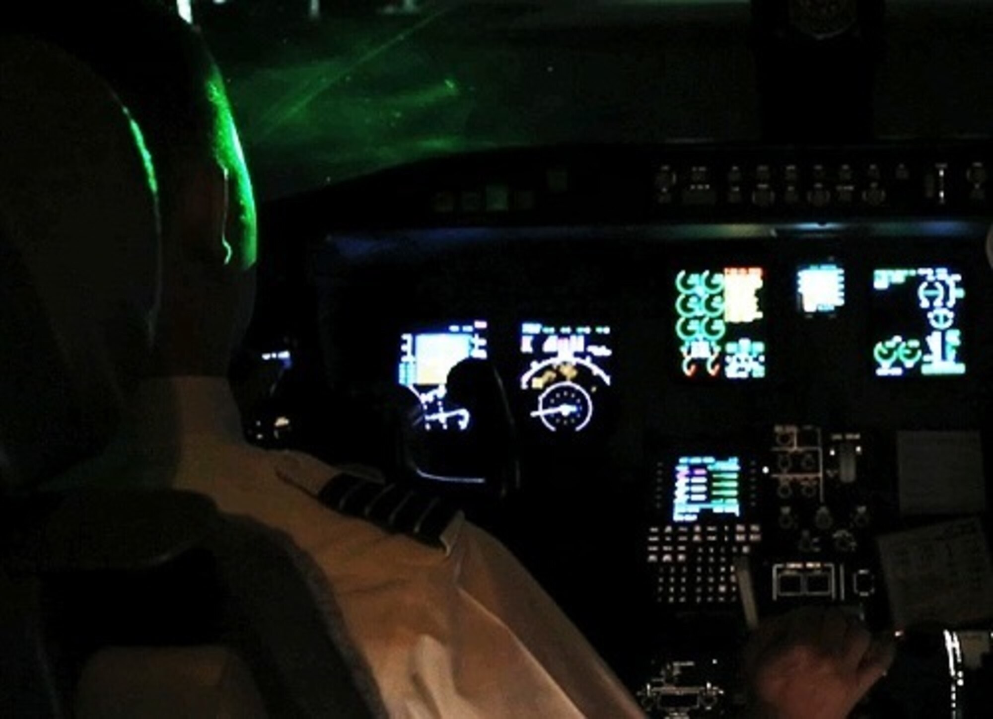 Laser light shines into an aircraft cockpit.