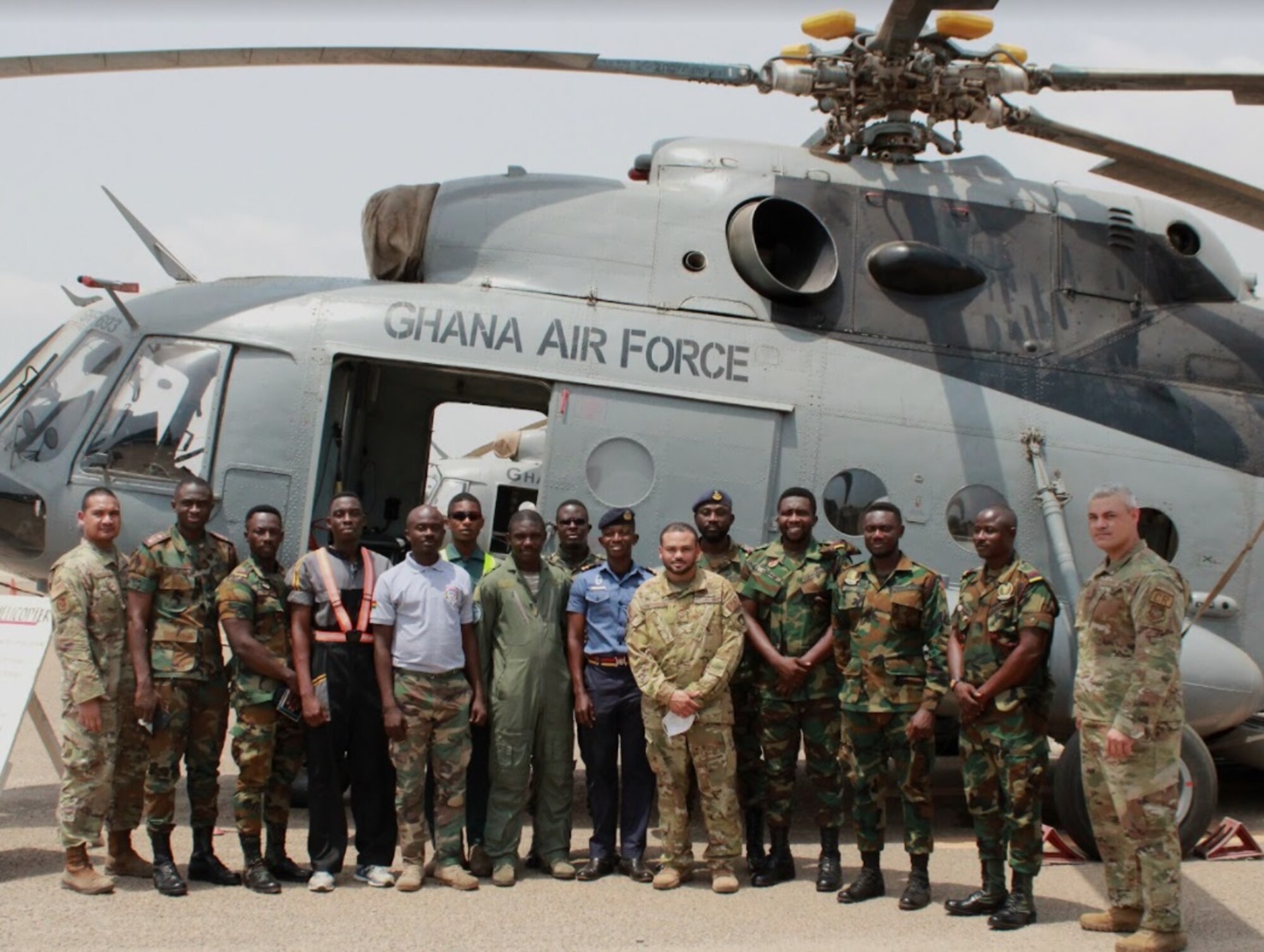 Air advisors assigned to the 818th Mobility Support Advisory Squadron and Ghanaian Armed Forces members pose for a photo in front of a Mil Mi-17 aircraft used for aeromedical evacuation training March 8, 2022, at Air Force Base, Accra, Ghana. Air advisors deployed to Ghana in support of the U.S. Africa Command’s African Peacekeeping Rapid Response Partnership Training program to prepare Ghanaian forces for an upcoming U.N. deployment. (Courtesy photo)