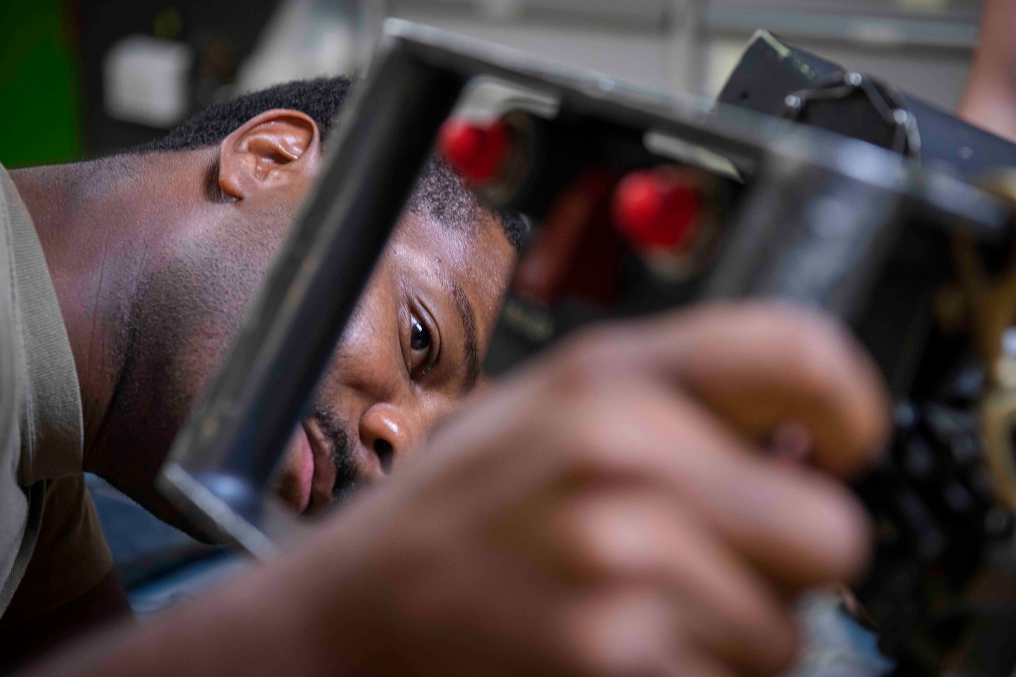 An Airman looks at a GAU-2 machine gun from the side