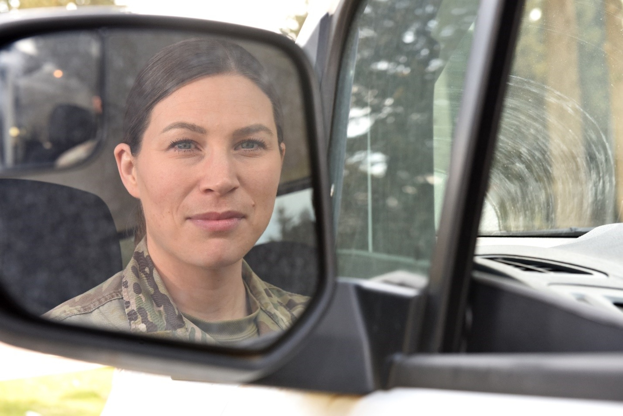 Tech Sgt. Rosemary Gudex, American Forces Network Incirlik operations manager, looks back in her car’s side-view mirror at Incirlik Air Base, Turkey, March 23, 2022. Gudex spent years healing from her experience growing up with an alcoholic father. She now focuses her time and energy on things that hold value to her, like fitness and developing Airmen. (U.S. Air Force photo by Tech. Sgt. Crystal L. Charriere)
