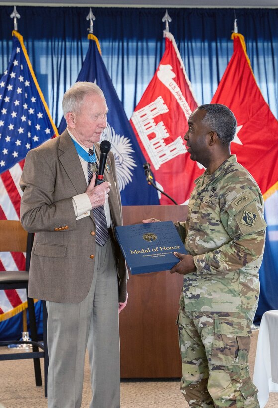 U.S. Marine Corps Maj. Gen. (retired) James Livingston (left) presents U.S. Army Brig. Gen. Jason Kelly, commander of the U.S. Army Corps Of Engineers South Atlantic Division, a signed Medal Of Honor book.  Livingston, a Medal Of Honor recipient, was a keynote speaker during the division's recent military Leadership Development Program.  Charleston District hosted the event.