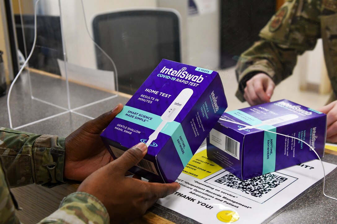 A soldier holds an at-home COVID-19 test.