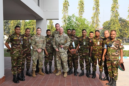 U.S. Army delegates pause for a photograph with Bangladeshi Army members, after the opening ceremony of the Exercise Tiger Lightning 2022, on March 20, 2022 at the Bangladesh Institute of Peace Support Operation Training center in Dhaka, Bangladesh. TL22 is a bilateral exercise sponsored by the U.S. Indo-Pacific Command and hosted by the Bangladesh Armed Forces, strengthening Bangladesh defense readiness, building operational interoperability, and reinforcing partnership between the Bangladesh Armed Forces and the Oregon National Guard. (Air National Guard photo by Master Sgt. Aaron Perkins, Oregon Military Department Public Affairs)