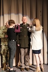 Brig. Gen. Joseph W. Green has his general’s stars pinned to his uniform by his family at his promotion ceremony March 13, 2022, at Draper, Utah.
