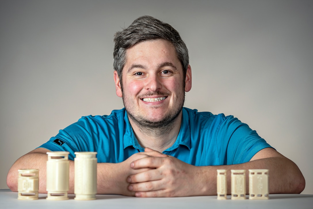 Brandon Rottle, nuclear general foreman, Code 950 (Shop 51/67), poses with the new X7 blown optic fiber clamps he and his team created for the Navy at Puget Sound Naval Shipyard & Intermediate Maintenance Facility in Bremerton, Washington. The U.S. Navy has patented the clamp design, which should help protect BOF cables aboard U.S. Navy ships. (PSNS & IMF photo by Scott Hansen)