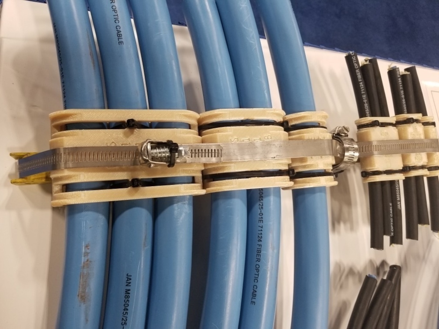 The thermoplastic blown optical fiber cable clamps designed by Brandon Rottle, nuclear general foreman, Shop 67, Marine Electronics, at Puget Sound Naval Shipyard & Intermediate Maintenance Facility.