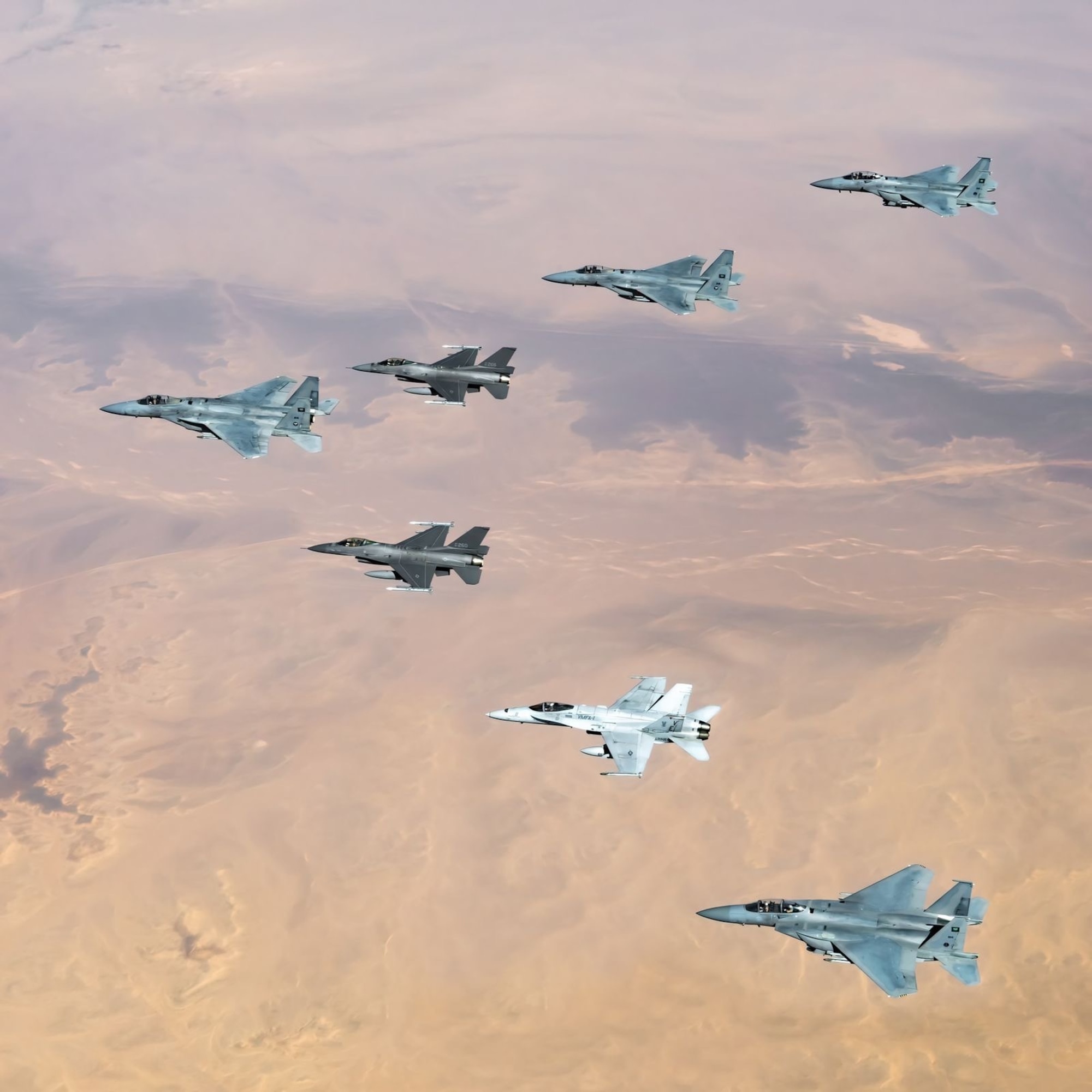 Royal Saudi Air Force F-15s fly alongside U.S. Air Force F-16 Fighting Falcons and a U.S. Marine Corps F/A-18 Hornet during Operation Agile Spartan II. Aircrew conducted Agile Combat Employment concepts throughout the U.S. Central Command area of responsibility during OAS II, which allows flexibility to operate from any location in a contested environment. (Courtesy Photo)