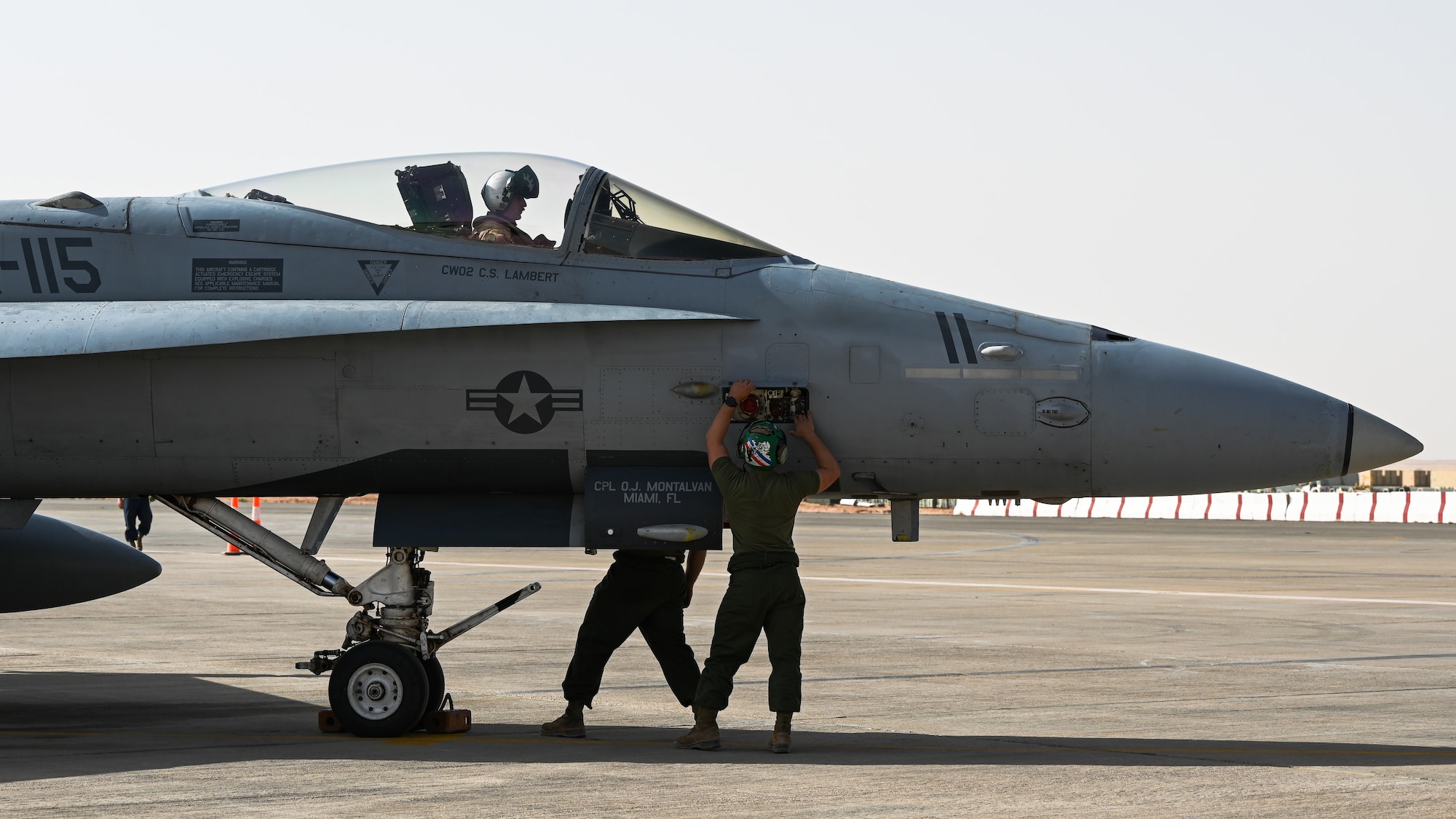 U.S. Marines from Marine Fighter Attack Squadron 115 perform inspections on an F/A-18 Hornet at Prince Sultan Air Base, Kingdom of Saudi Arabia, Jan. 25, 2022. The VMFA-115 deployed to PSAB to maximize regional capabilities in regards to mutual security concerns. (U.S. Air Force photo by Staff Sgt. Christina A. Graves)