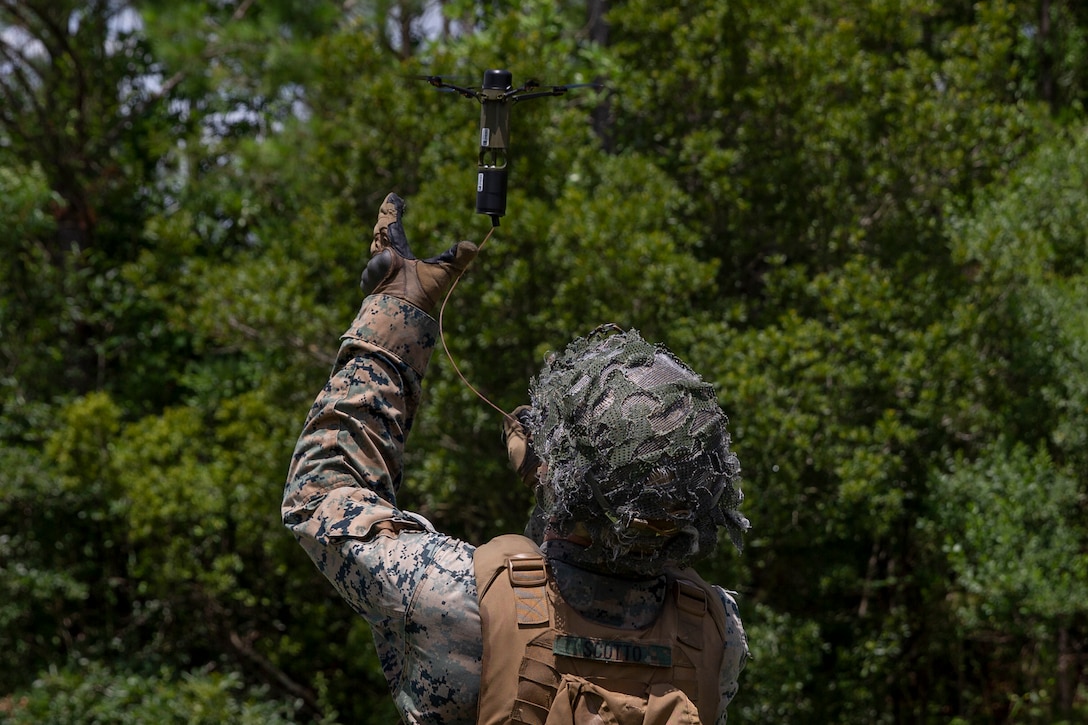 U.S. Marine Corps Lance Cpl. Michael Scotto, a native of Islip, N.Y., and a rifleman with 1st Battalion, 2d Marine Regiment (1/2), 2d Marine Division (2d MARDIV), retrieves a Drone-40 during a training exercise at Camp Lejeune, N.C., July 7, 2021. 1/2 is tasked as 2d MARDIV’s experimental infantry battalion to test new gear, operating concepts and force structures. The unit’s findings will help refine infantry battalions across the Marine Corps in accordance with Force Design 2030. (U.S. Marine Corps photo by Pfc. Sarah Pysher)