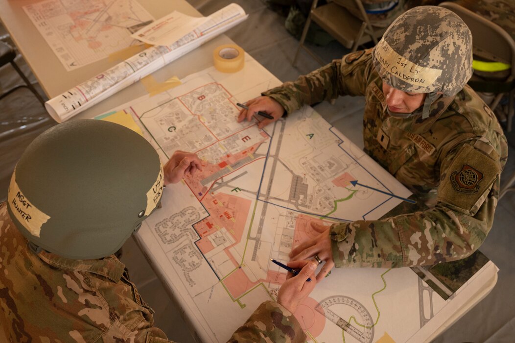 Airmen look at map