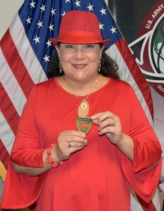 Migdalia “Miggy” Boyle poses with a 4-star commander’s coin presented virtually Feb. 10 by Gen. Ed Daly, commanding general of U.S. Army Materiel Command. Boyle, inventory manager for the Army’s Medical Chemical Defense Materiel program, will retire in May, capping off a 38-year career in federal service, including the past 16 years with the U.S. Army Medical Materiel Agency at Fort Detrick, Maryland.