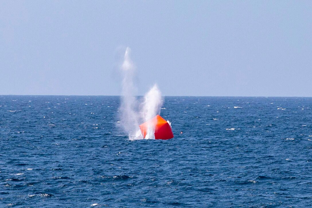 A red inflatable target in waters.