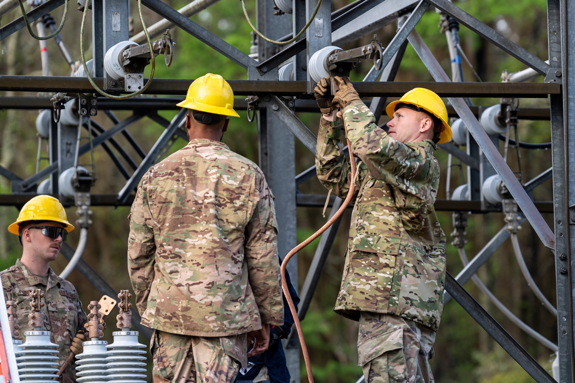 Photo of an Airman replacing a breaker during a power outage.