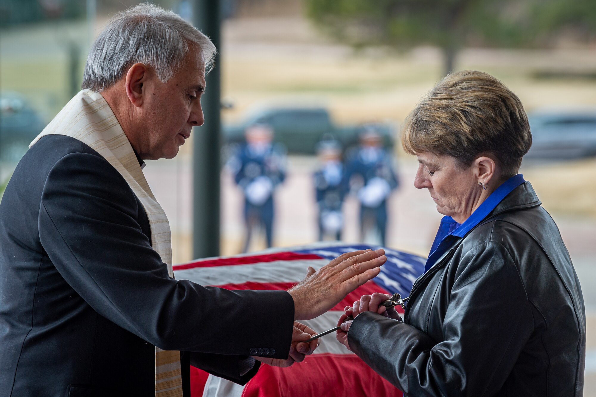 Father Bruno and Kay Scott hold a cross, as Bruno blesses it during a funeral service for Lt. Gen. Winfield Scott, the Air Force Academy's 10th superintendent, March 29, 2022. General Scott passed away on March 19, 2022.